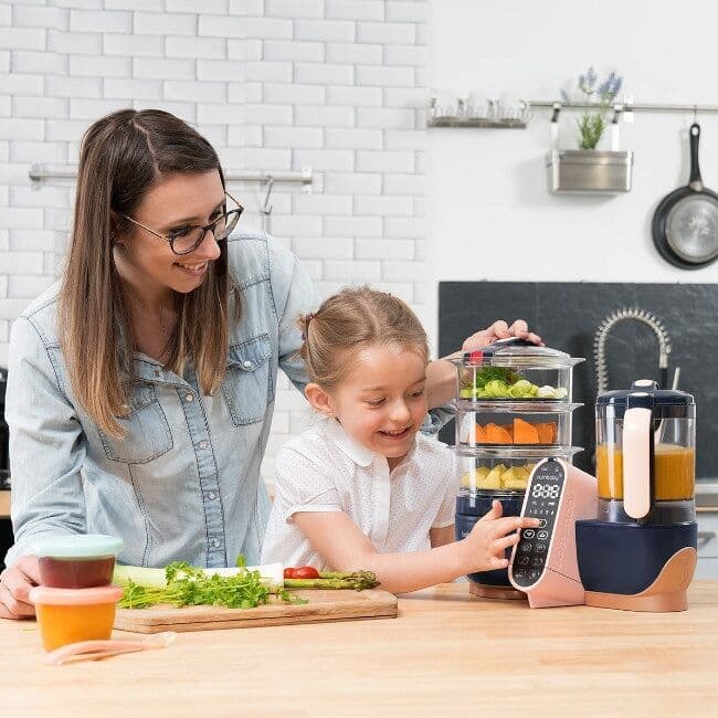 Three small plants being held by hands